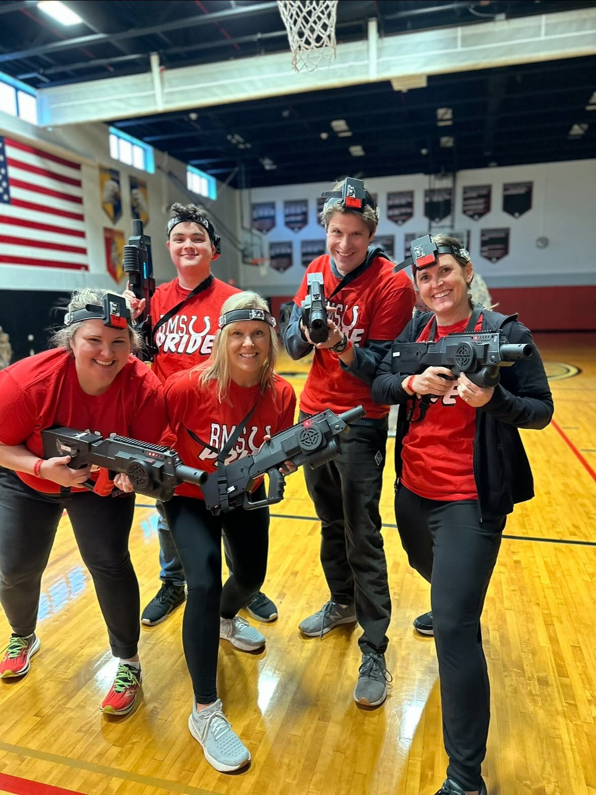 Team playing laser tag in a gym